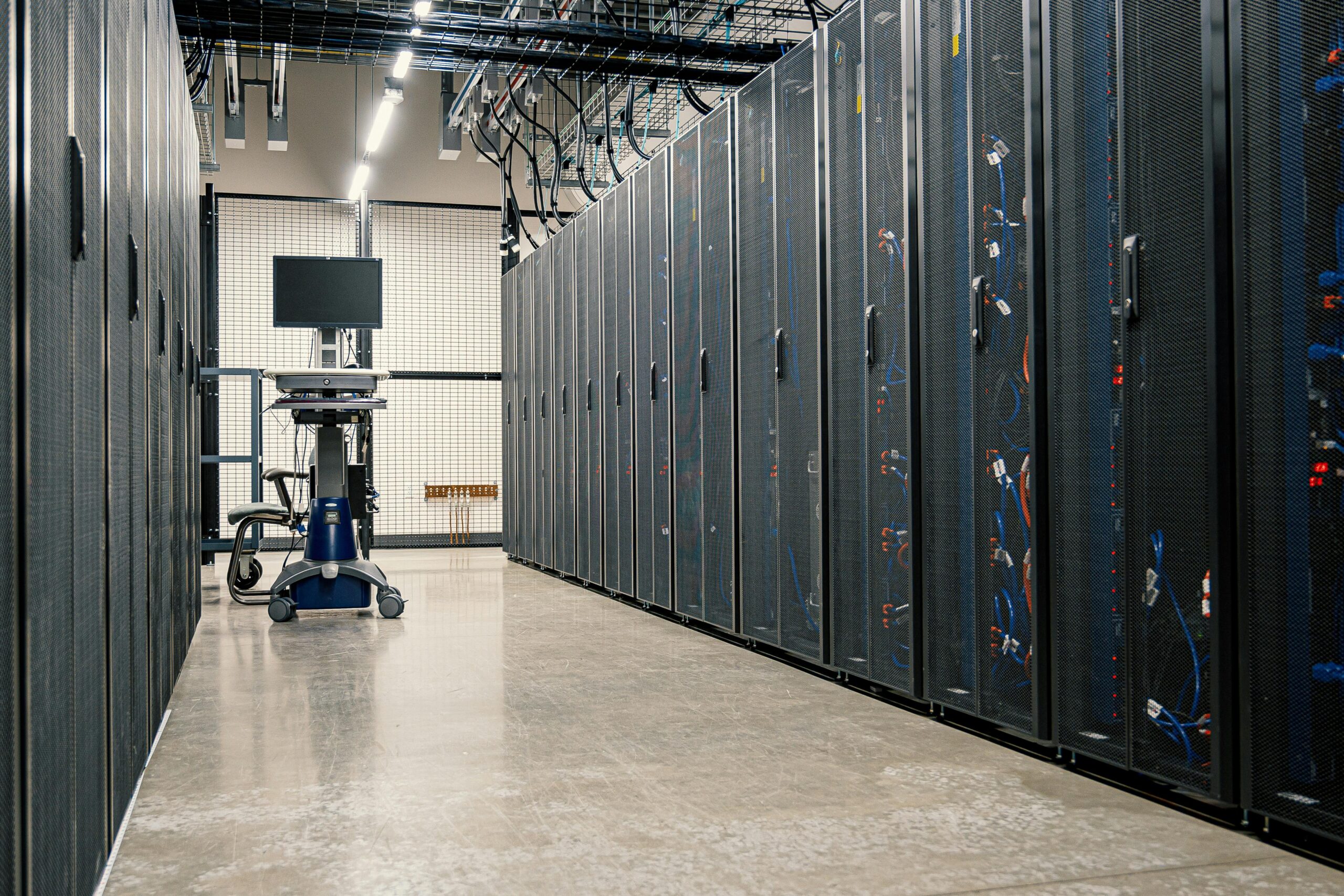 Steel framework cabinets housing servers networking devices and cables in contemporary equipped data center